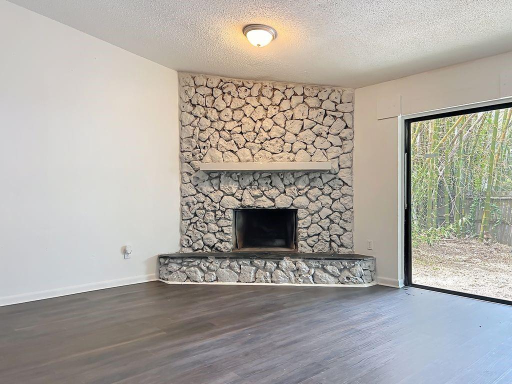 5214 2nd Street Orlando, FL 32810 - Photo 26 of 50 a living room with a fireplace and a floor to ceiling window