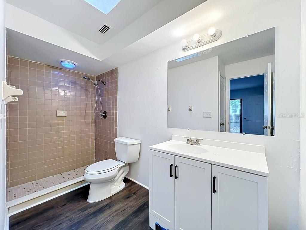 5214 2nd Street Orlando, FL 32810 - Photo 30 of 50 a bathroom with a sink toilet a mirror and shower