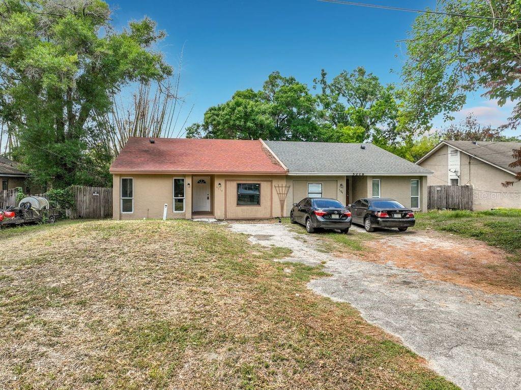 5214 2nd Street Orlando, FL 32810 - Photo 3 of 50 a front view of a house with a yard and garage