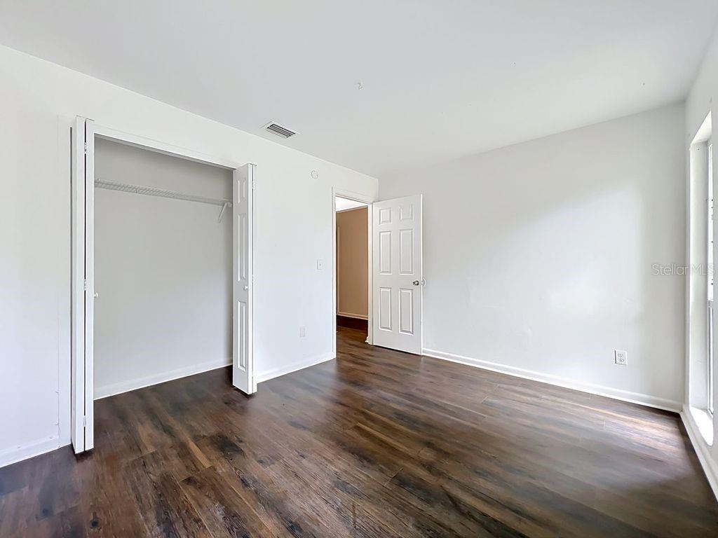 5214 2nd Street Orlando, FL 32810 - Photo 33 of 50 a view of an empty room with wooden floor and closet