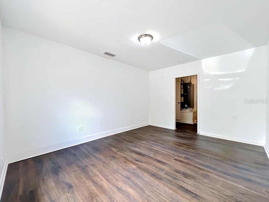 5214 2nd Street Orlando, FL 32810 - Photo 35 of 50 a view of an empty room with wooden floor and a window
