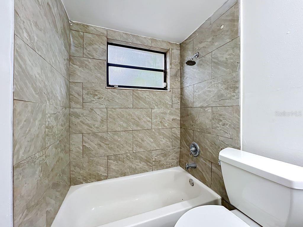 5214 2nd Street Orlando, FL 32810 - Photo 38 of 50 a bathroom with a toilet and a bathtub