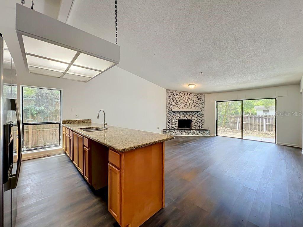 5214 2nd Street Orlando, FL 32810 - Photo 10 of 50 a kitchen with stove and wooden floor
