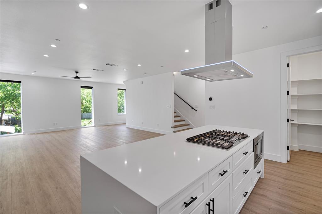 a kitchen with stainless steel appliances a white counter top and stove