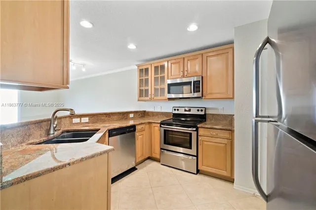 a kitchen with a sink stove and refrigerator
