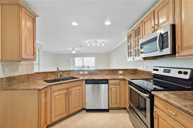 a kitchen with stainless steel appliances granite countertop a sink stove and cabinets