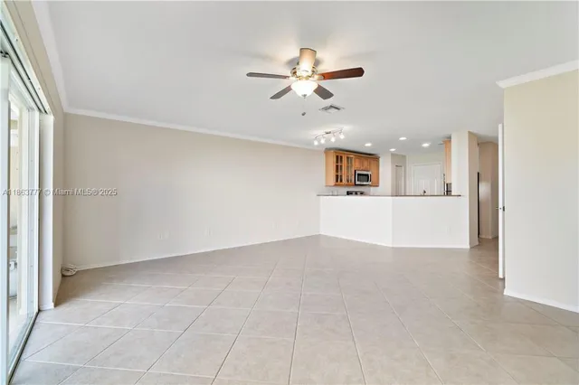 a view of a kitchen with furniture and ceiling fan