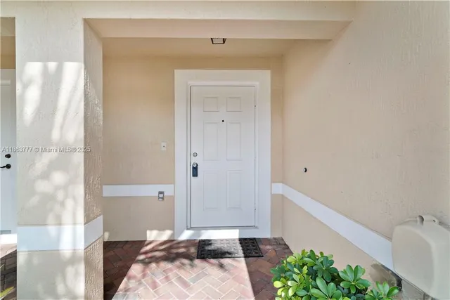 a bedroom with a bed and a potted plant