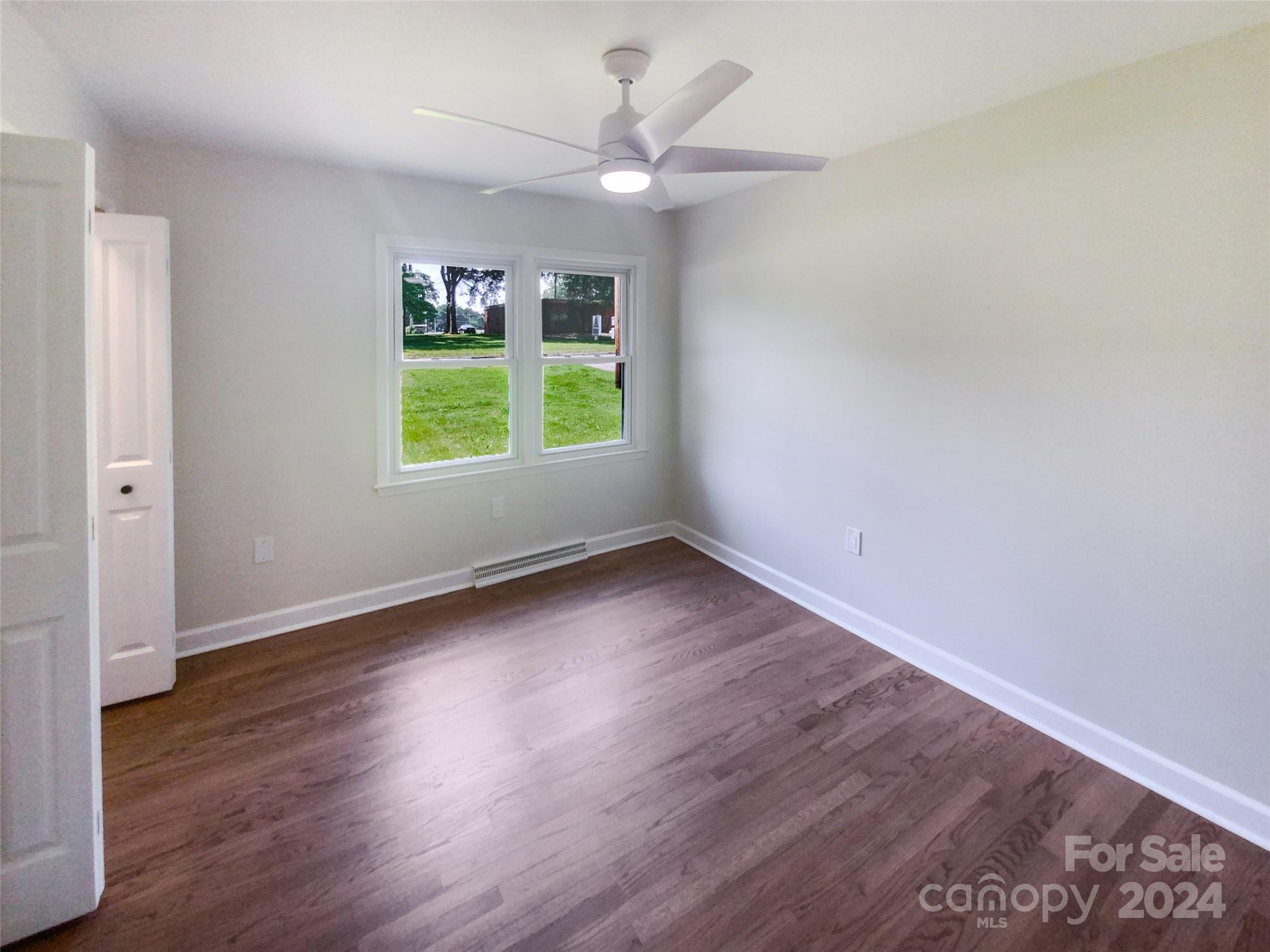1110 Radio Road Statesville, NC 28677 - Photo 14 of 21 an empty room with wooden floor and windows