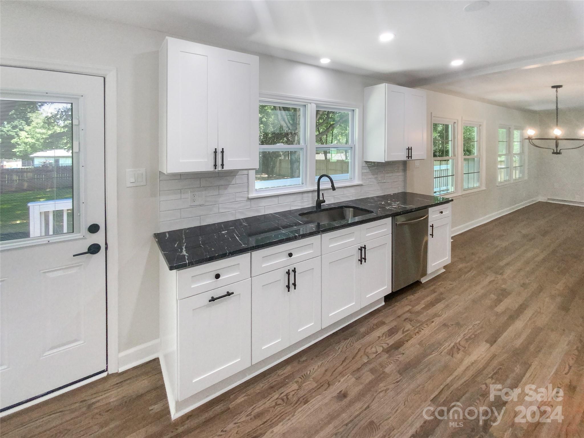 1110 Radio Road Statesville, NC 28677 - Photo 8 of 21 a kitchen with granite countertop a sink a window and stainless steel appliances