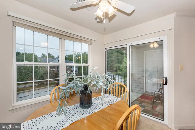 a view of a dining room with furniture a chandelier and wooden floor