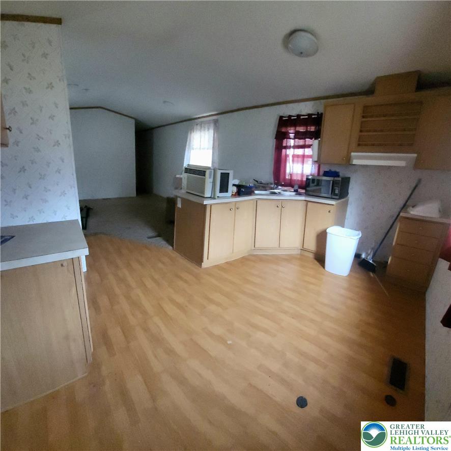 1115 Smithlane Road Lehighton, PA 18235 - Photo 17 of 24 a kitchen with stainless steel appliances kitchen island wooden cabinets and a granite counter tops