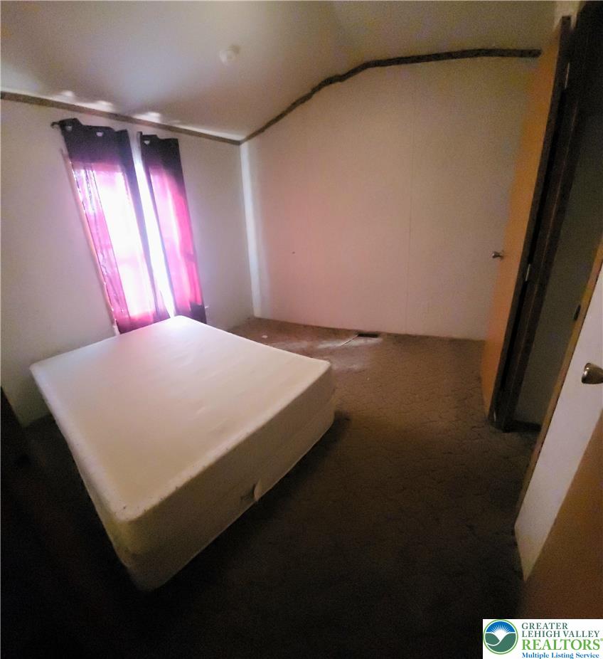 1115 Smithlane Road Lehighton, PA 18235 - Photo 24 of 24 a bed sitting in a bedroom next to a window