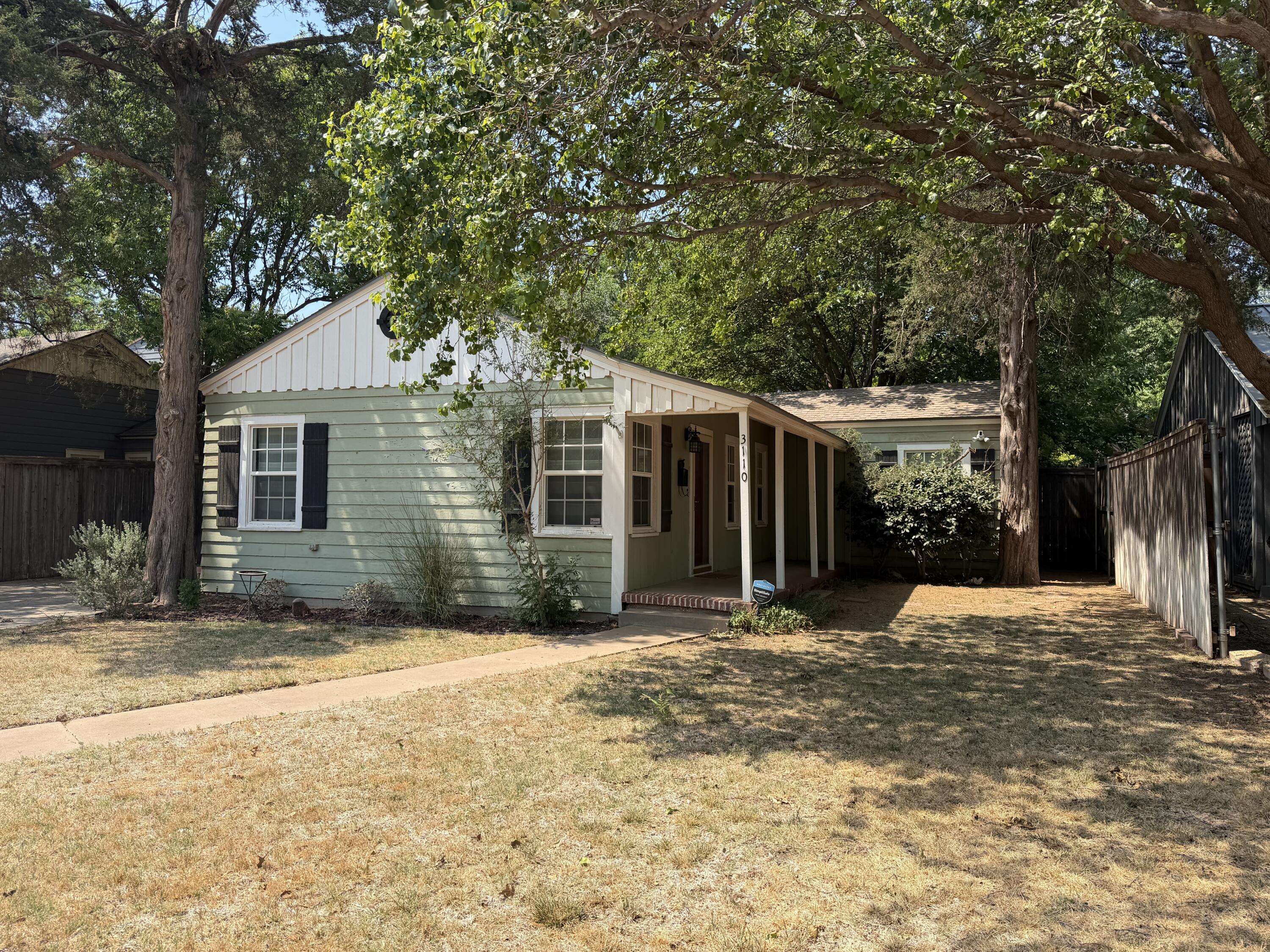 3110 22nd Street Lubbock, TX 79410 - Photo 1 of 22 a front view of a house with a yard and potted plants