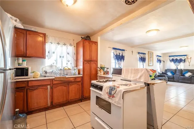 a kitchen that has a sink and a stove in it