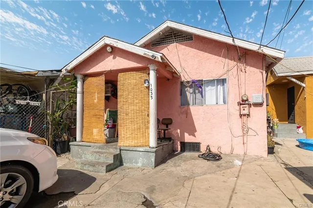 a view of house with backyard and parking