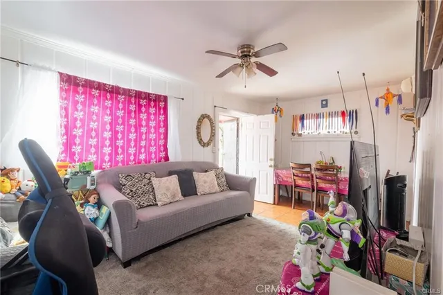 a living room with patio furniture and a flat screen tv