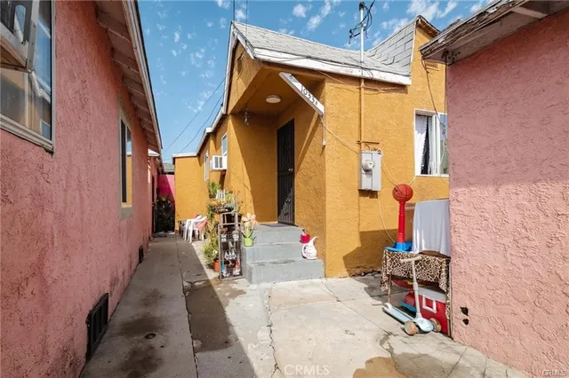 a living room with patio furniture and a flat screen tv