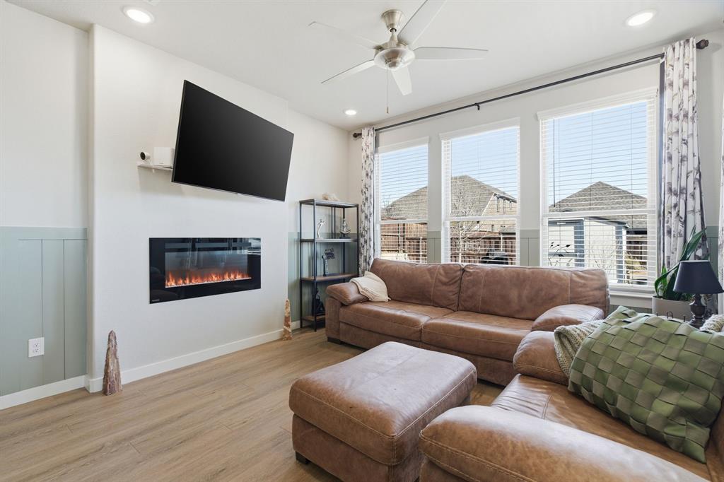 5613 Smt Crk Road Fort Worth, TX 76126 - Photo 11 of 40 a living room with furniture a flat screen tv and a fireplace