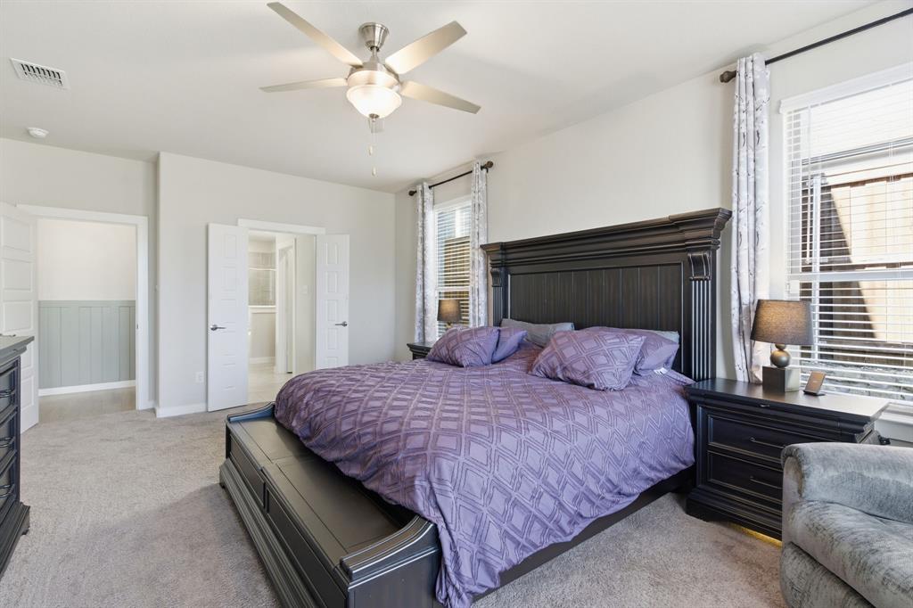 5613 Smt Crk Road Fort Worth, TX 76126 - Photo 17 of 40 a bedroom with a large bed and a chandelier