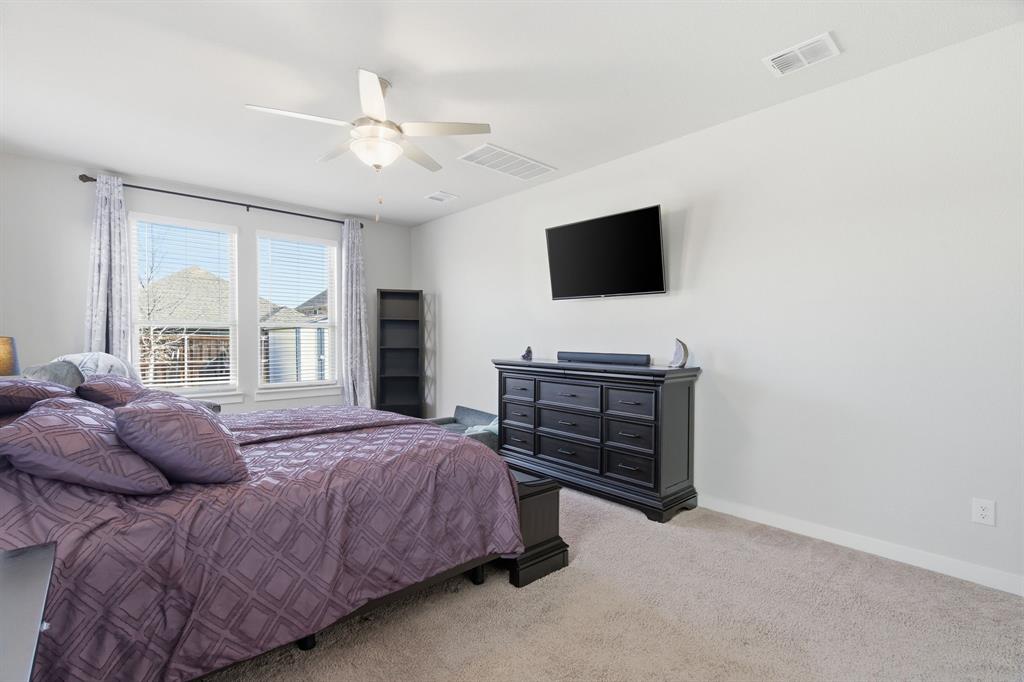 5613 Smt Crk Road Fort Worth, TX 76126 - Photo 18 of 40 a bedroom with a bed and a flat screen tv