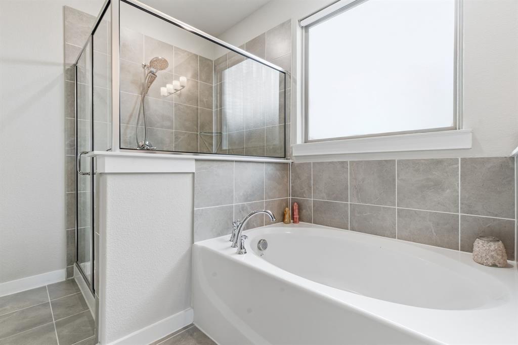 5613 Smt Crk Road Fort Worth, TX 76126 - Photo 21 of 40 a white bath tub sitting next to a window