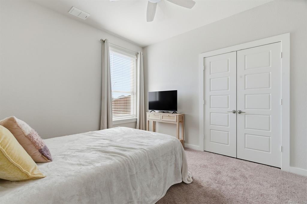 5613 Smt Crk Road Fort Worth, TX 76126 - Photo 32 of 40 a bedroom with a bed and a flat screen tv