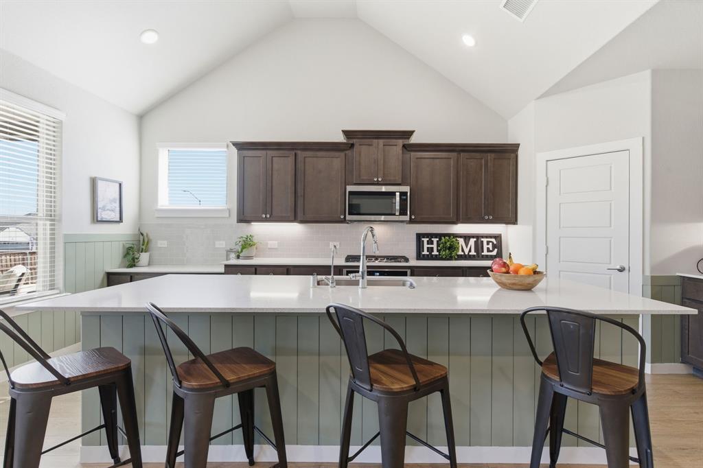 5613 Smt Crk Road Fort Worth, TX 76126 - Photo 4 of 40 a kitchen with stainless steel appliances a table chairs refrigerator and microwave