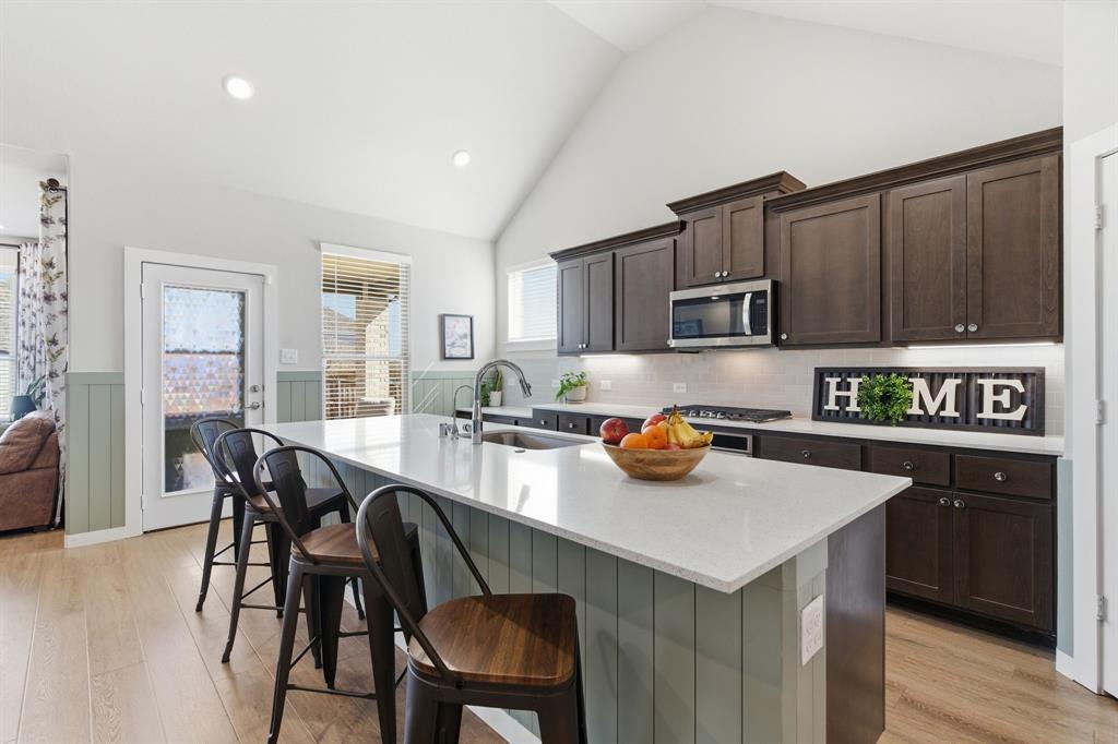 5613 Smt Crk Road Fort Worth, TX 76126 - Photo 6 of 40 a kitchen with a sink a stove and chairs