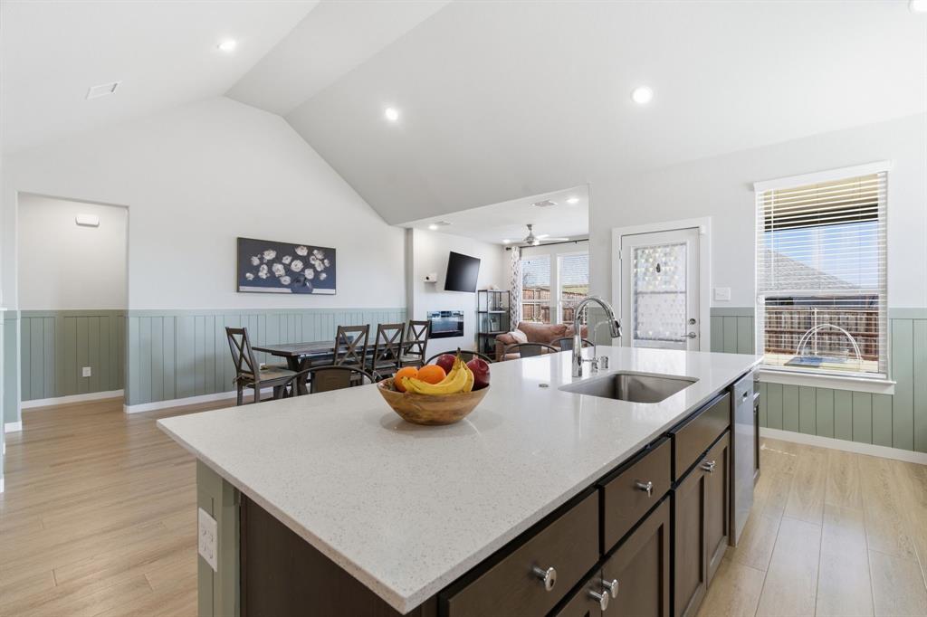 5613 Smt Crk Road Fort Worth, TX 76126 - Photo 8 of 40 a kitchen with a sink a counter and chairs