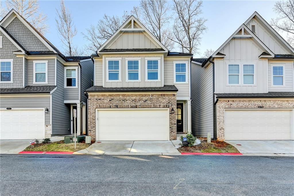 682 Smokey Quartz Way Kennesaw, GA 30144 - Photo 1 of 49 a front view of a house with multi story windows
