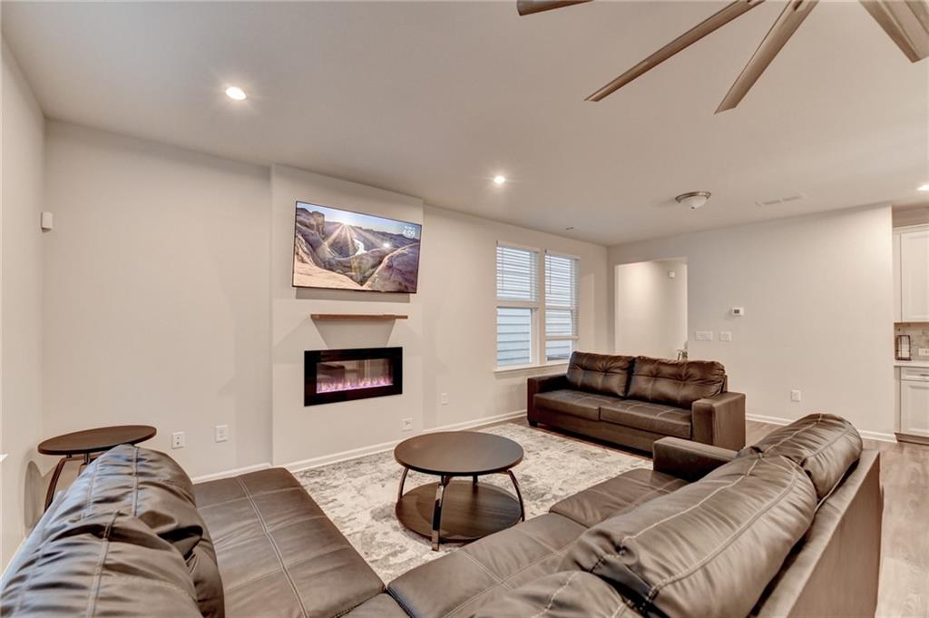 682 Smokey Quartz Way Kennesaw, GA 30144 - Photo 11 of 49 a living room with furniture a rug and a fireplace