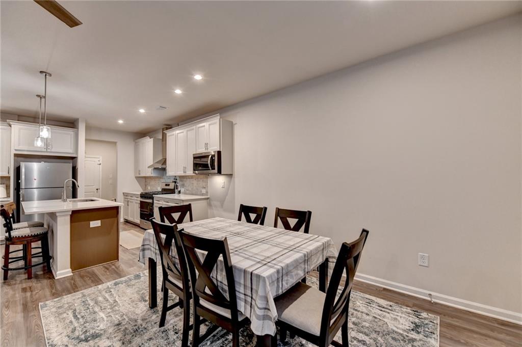 682 Smokey Quartz Way Kennesaw, GA 30144 - Photo 12 of 49 a view of a dining room with furniture