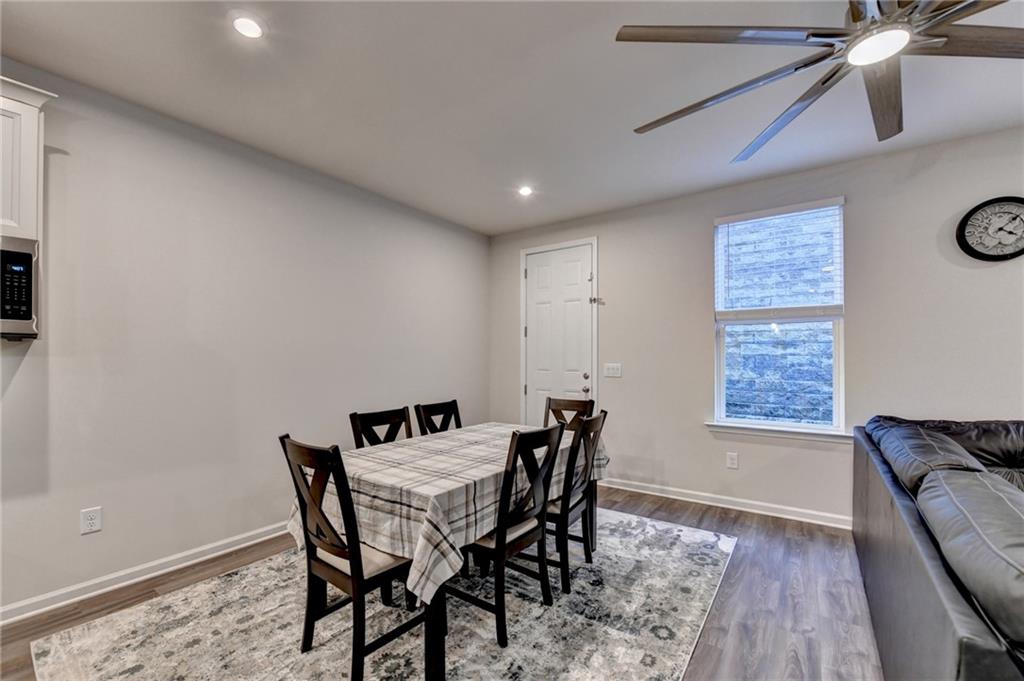 682 Smokey Quartz Way Kennesaw, GA 30144 - Photo 13 of 49 a view of a dining room with furniture and wooden floor