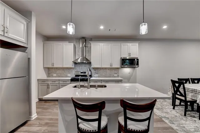 a stove top oven sitting inside of a kitchen