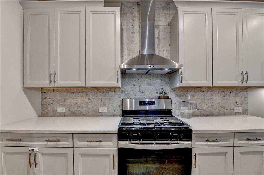 682 Smokey Quartz Way Kennesaw, GA 30144 - Photo 19 of 49 a stove top oven sitting inside of a kitchen