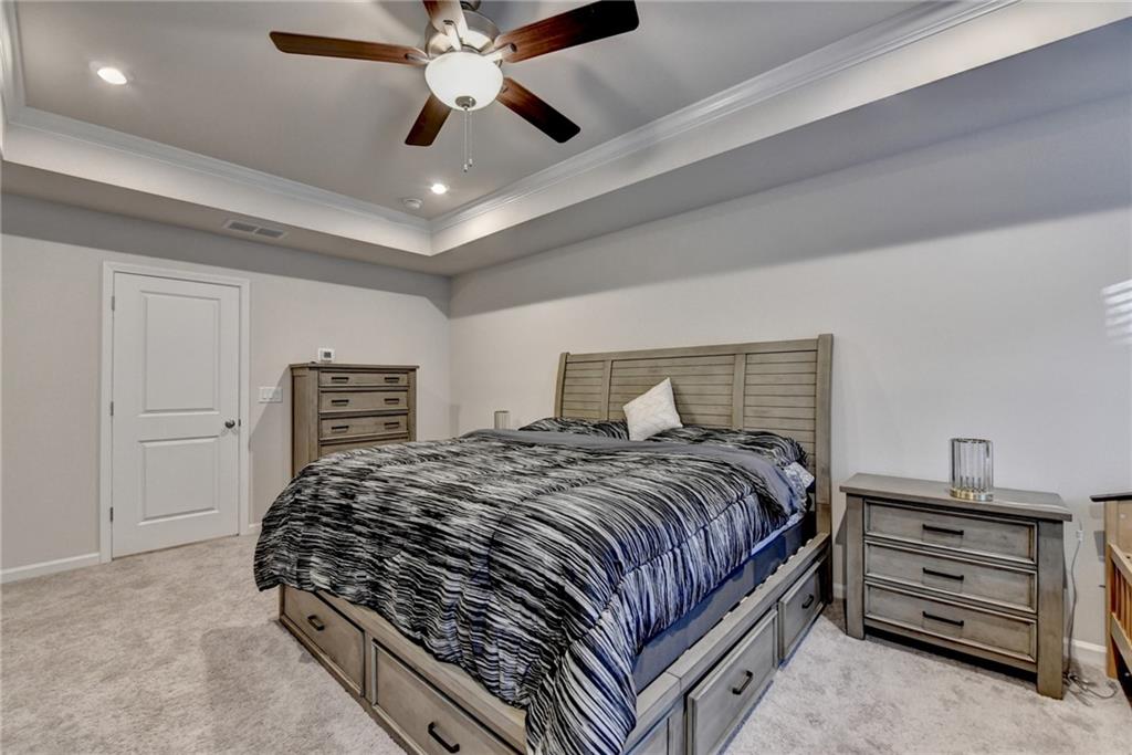 682 Smokey Quartz Way Kennesaw, GA 30144 - Photo 30 of 49 a bedroom with a bed and a chandelier