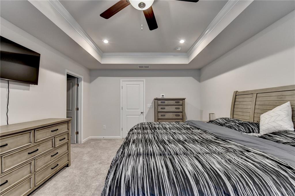 682 Smokey Quartz Way Kennesaw, GA 30144 - Photo 31 of 49 a bedroom with a bed and flat screen tv