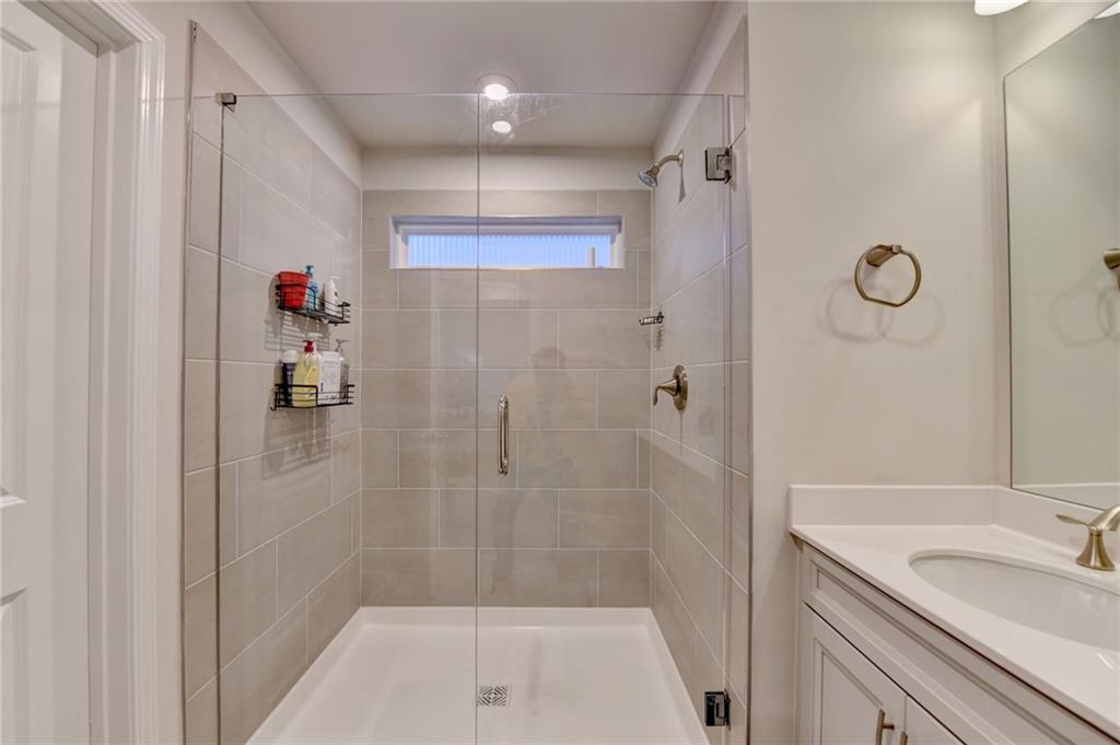 682 Smokey Quartz Way Kennesaw, GA 30144 - Photo 33 of 49 a bathroom with a shower and a sink