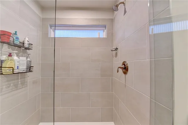 a view of walk in closet with clothes