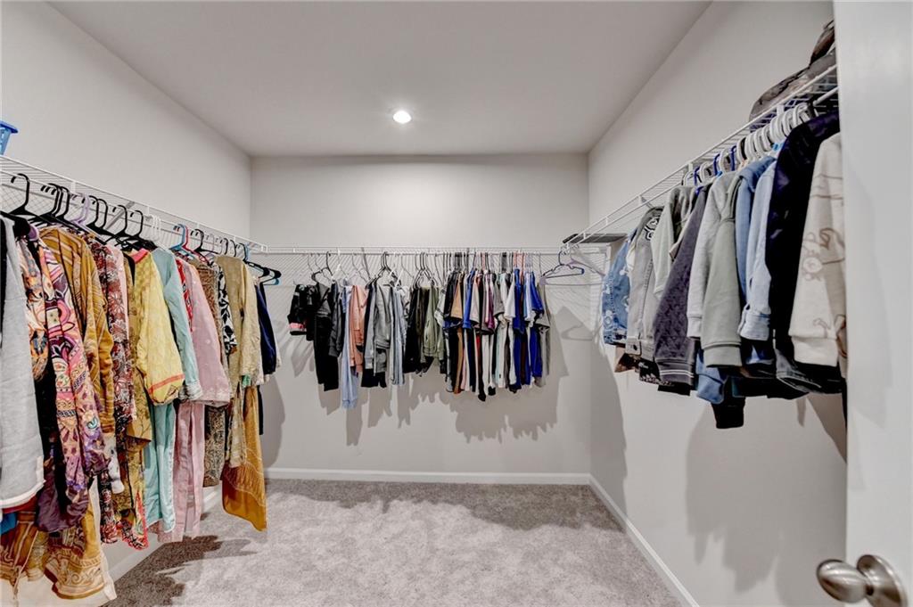 682 Smokey Quartz Way Kennesaw, GA 30144 - Photo 36 of 49 a view of walk in closet with clothes