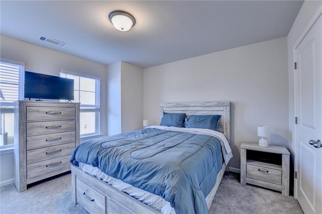 682 Smokey Quartz Way Kennesaw, GA 30144 - Photo 40 of 49 a bedroom with a bed and a television