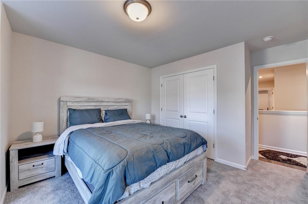 682 Smokey Quartz Way Kennesaw, GA 30144 - Photo 41 of 49 a bedroom with a bed and a lamp