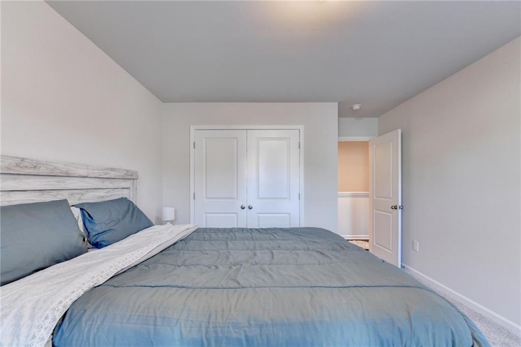 682 Smokey Quartz Way Kennesaw, GA 30144 - Photo 42 of 49 a bedroom with a bed and a window