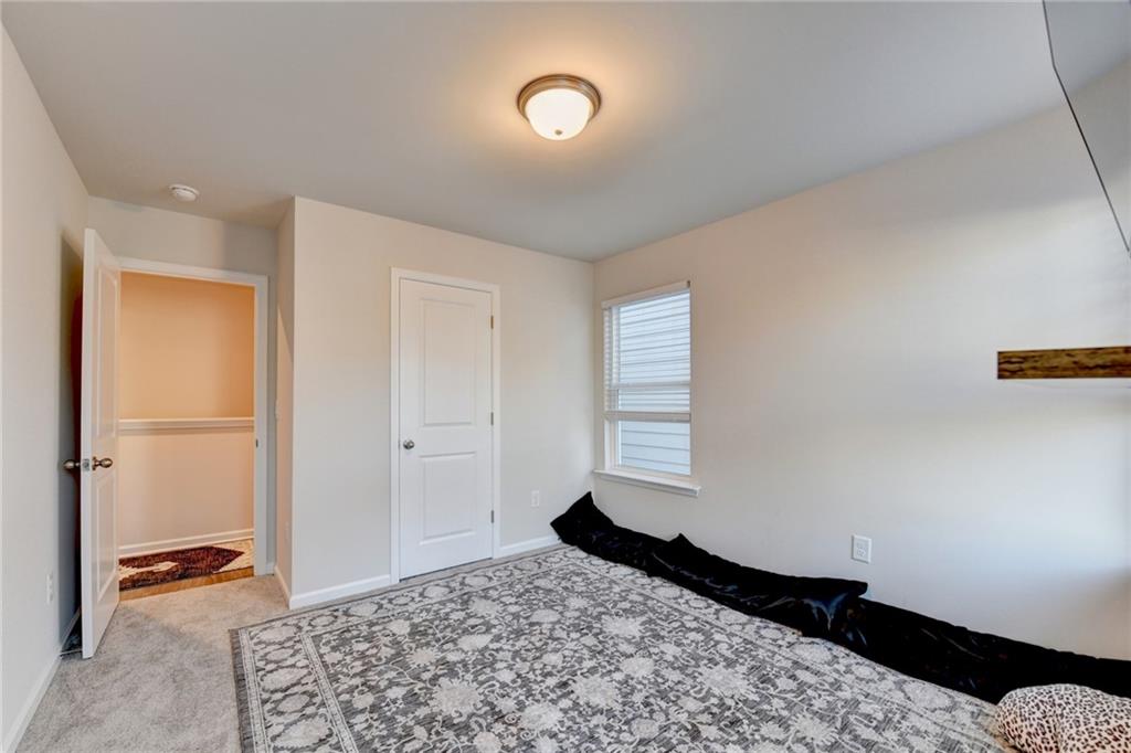 682 Smokey Quartz Way Kennesaw, GA 30144 - Photo 45 of 49 a bedroom with a bed and a window