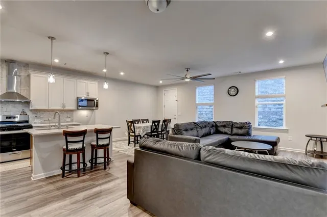a living room with furniture and a wooden floor