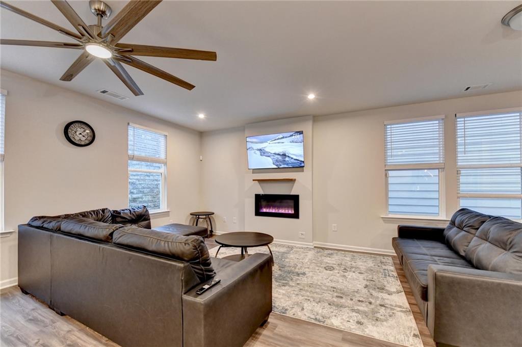 682 Smokey Quartz Way Kennesaw, GA 30144 - Photo 9 of 49 a living room with furniture and a fireplace
