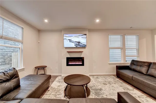 a living room with furniture a rug and a fireplace