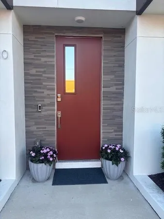 a table and a potted plant in front of a door