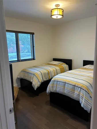a bedroom with two beds and a window